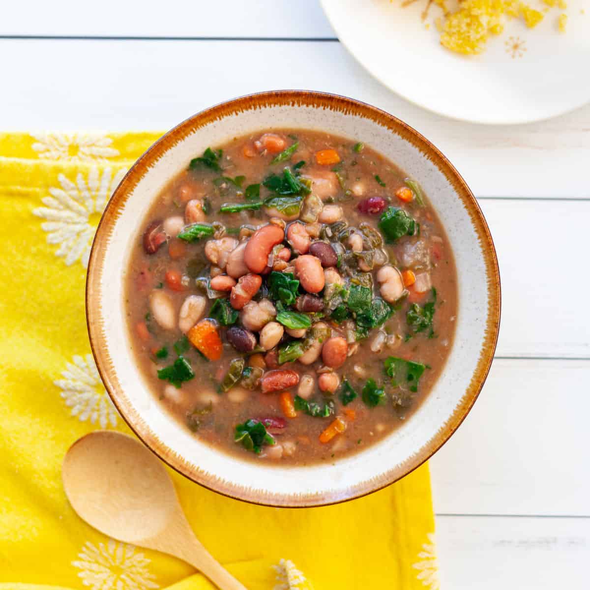 a bowl of bean soup sitting on a yellow towel
